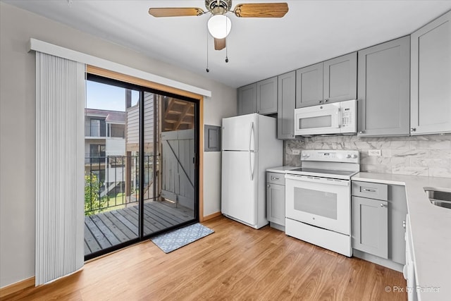 kitchen with tasteful backsplash, ceiling fan, white appliances, and light hardwood / wood-style flooring