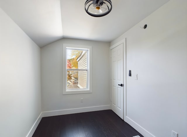 bonus room featuring dark wood-type flooring and vaulted ceiling