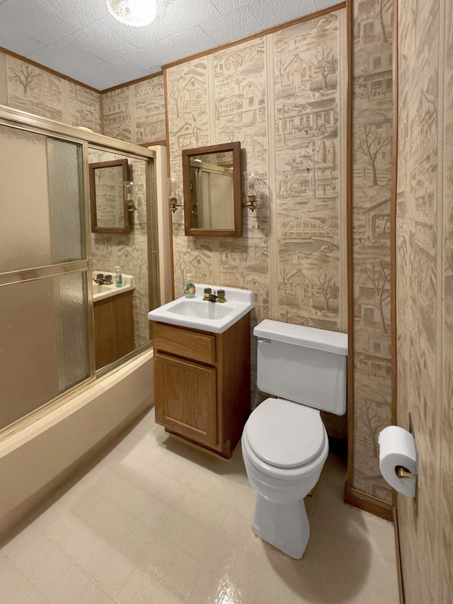 full bathroom with shower / bath combination with glass door, vanity, a textured ceiling, and toilet