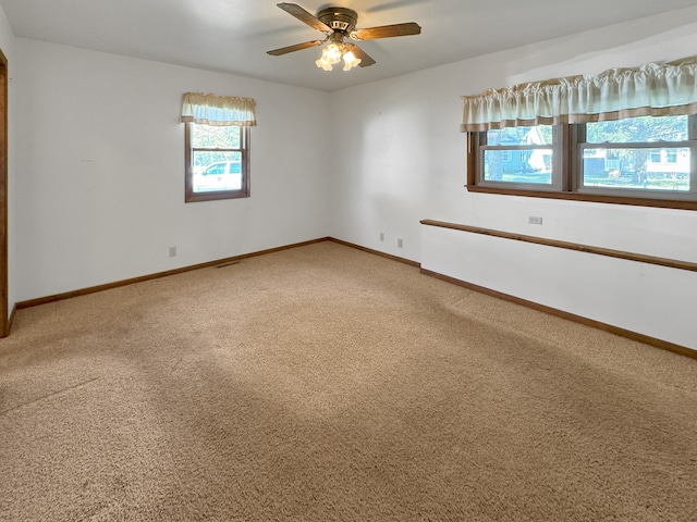 spare room with ceiling fan and carpet floors