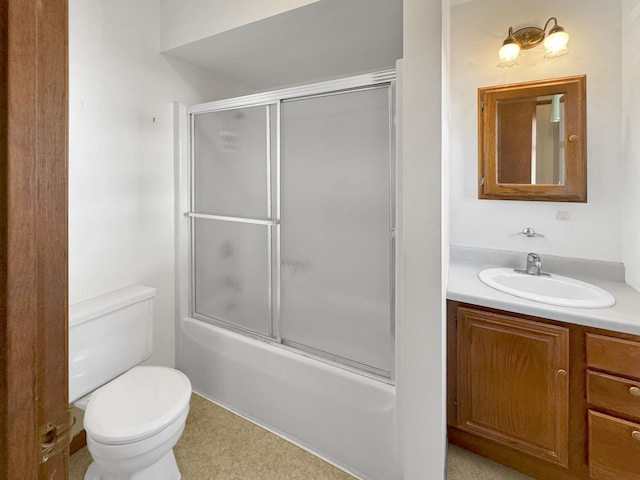 full bathroom with vanity, enclosed tub / shower combo, and toilet