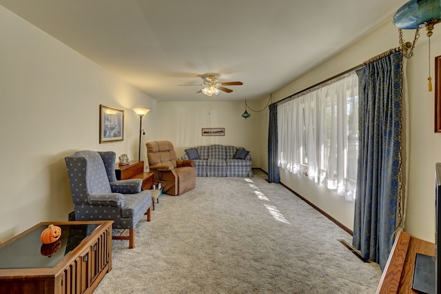 living room with ceiling fan and carpet