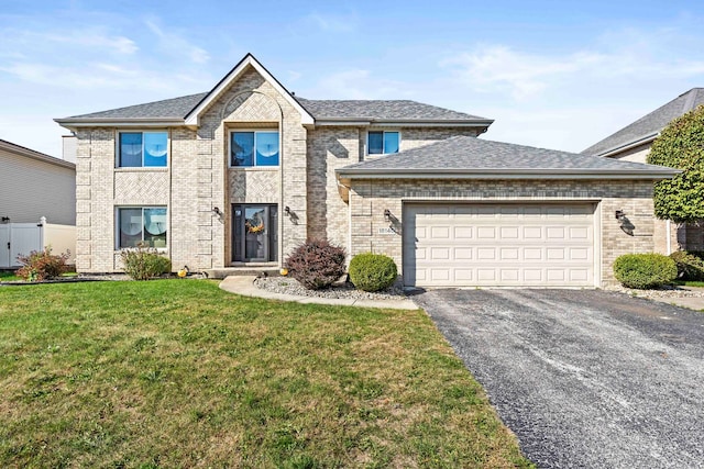 view of front of home with a front yard and a garage