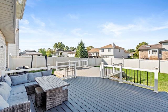 wooden terrace featuring an outdoor living space and a lawn