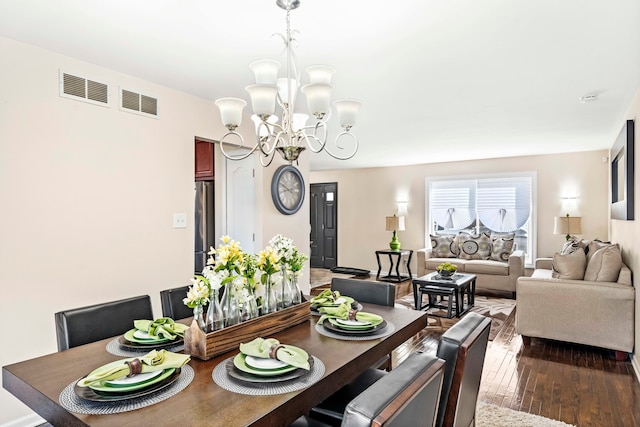 dining room with a notable chandelier and dark hardwood / wood-style flooring