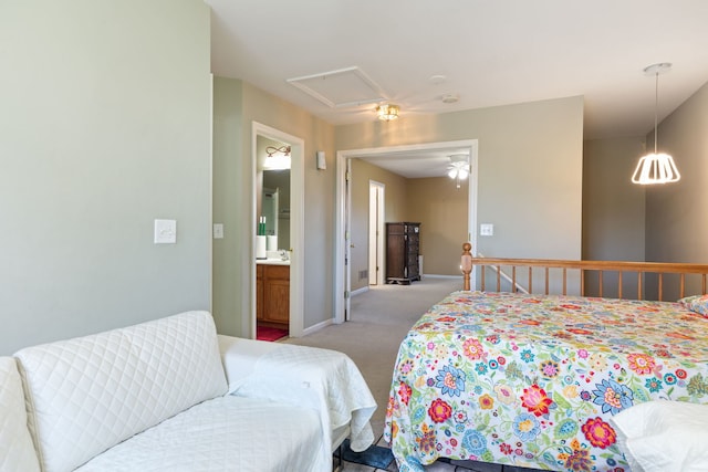 carpeted bedroom with ensuite bath and sink