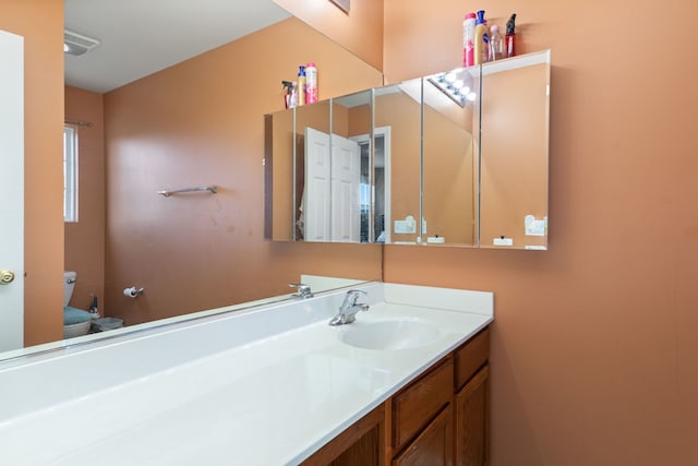 bathroom featuring vanity and toilet