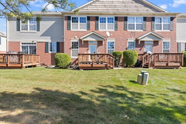 back of property with a lawn and a deck