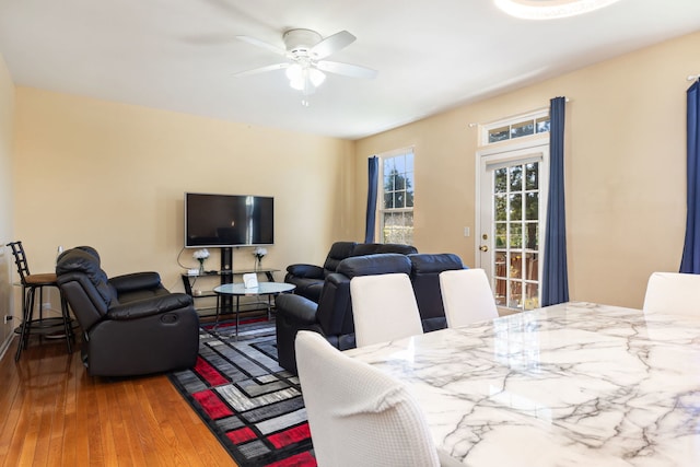 dining room with wood-type flooring and ceiling fan