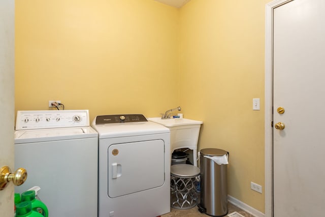 laundry area featuring independent washer and dryer and sink