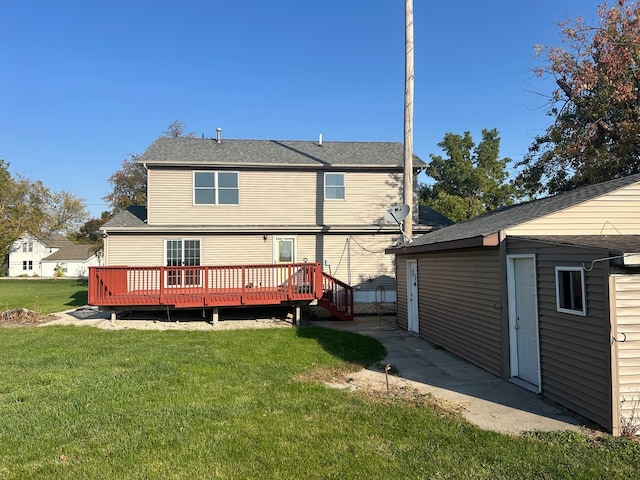 rear view of property with a deck and a lawn