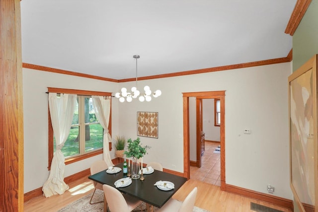 unfurnished dining area featuring ornamental molding, a chandelier, and light hardwood / wood-style floors