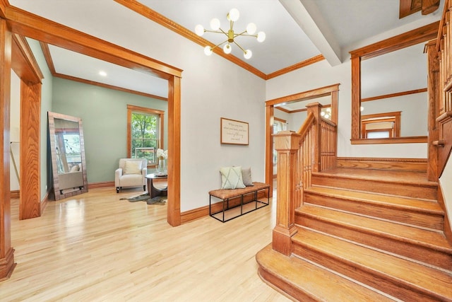 staircase with ornamental molding, wood finished floors, a chandelier, beamed ceiling, and baseboards