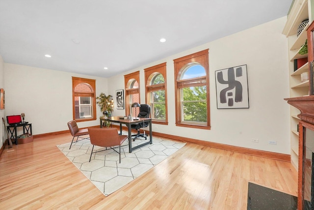 dining room featuring a fireplace and light hardwood / wood-style flooring