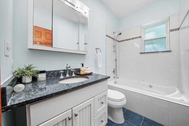 full bathroom featuring tiled shower / bath combo, vanity, tile patterned flooring, and toilet