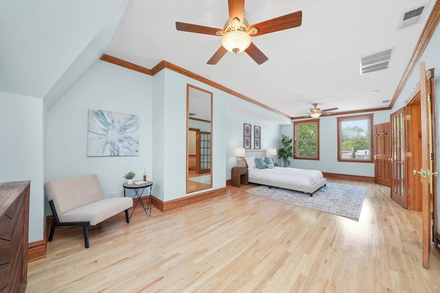 bedroom with lofted ceiling, crown molding, and light hardwood / wood-style floors