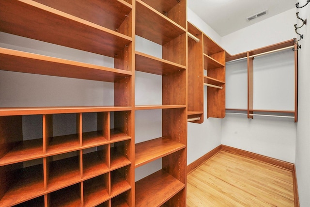 spacious closet featuring light hardwood / wood-style floors