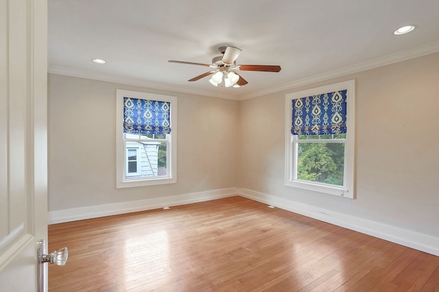 empty room featuring ornamental molding, ceiling fan, light hardwood / wood-style floors, and plenty of natural light