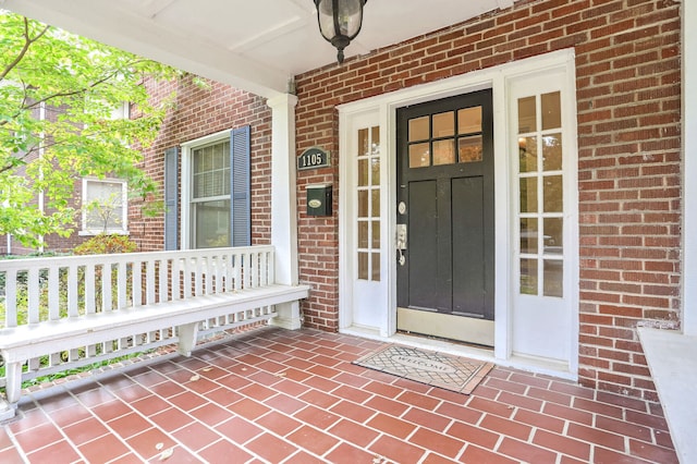 view of exterior entry with covered porch