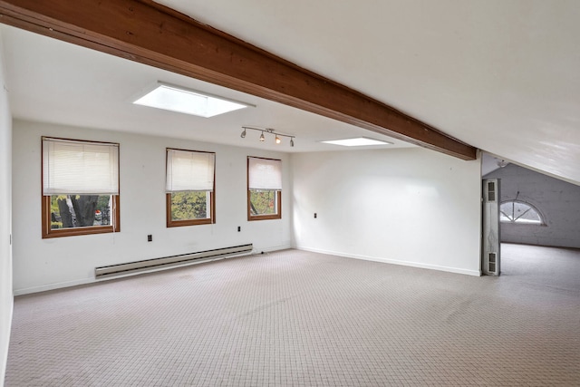 bonus room with vaulted ceiling with skylight, baseboard heating, and light colored carpet