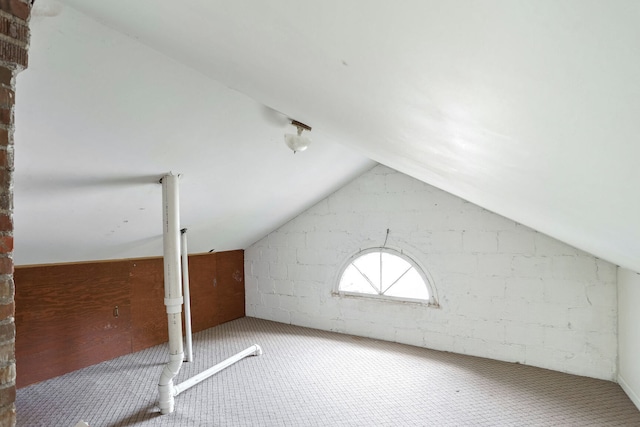 bonus room with carpet flooring and vaulted ceiling