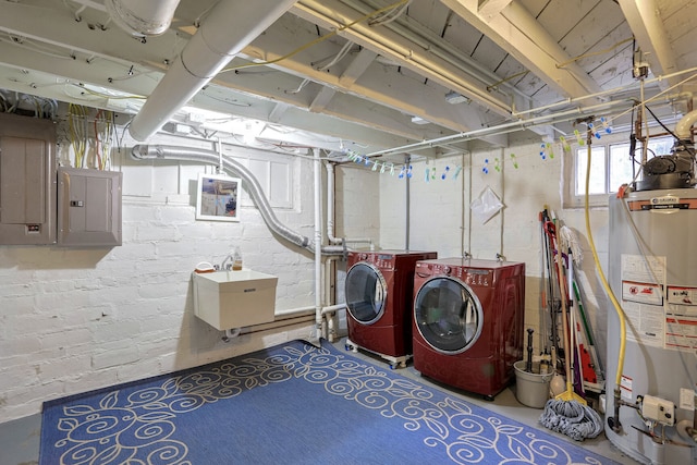 laundry room featuring sink, gas water heater, electric panel, and washing machine and clothes dryer