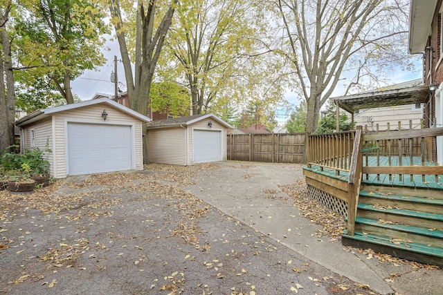 exterior space featuring a deck, an outbuilding, and a garage