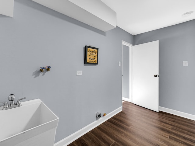 laundry area with sink, hookup for a washing machine, and dark hardwood / wood-style flooring