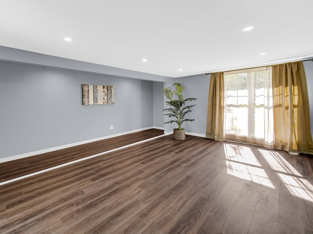 empty room featuring dark wood-type flooring