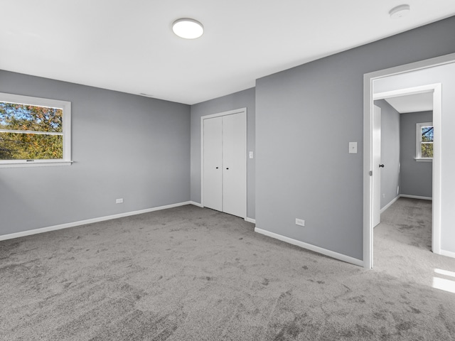 unfurnished bedroom featuring carpet floors and a closet