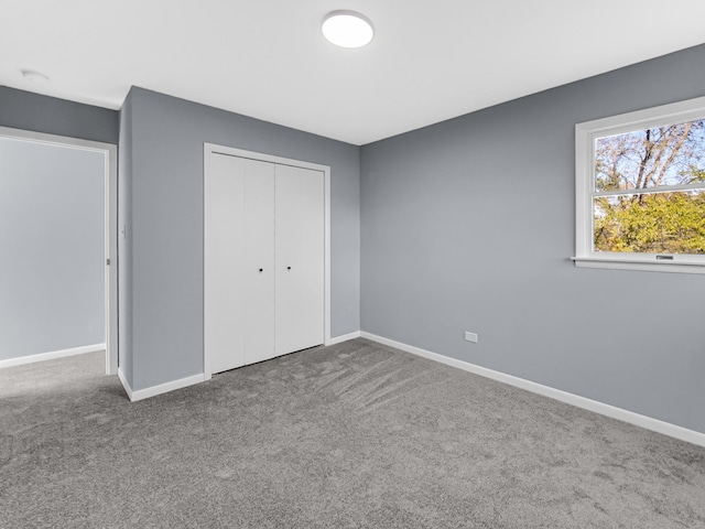 unfurnished bedroom with a closet and carpet floors