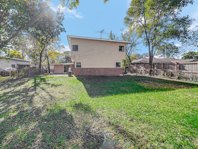 rear view of house featuring a yard