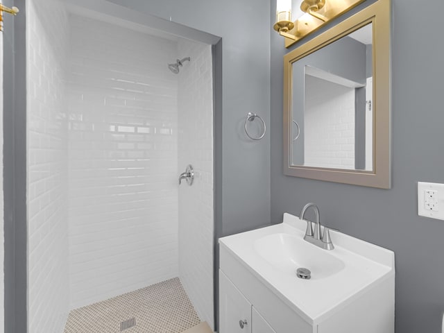 bathroom featuring vanity and a tile shower