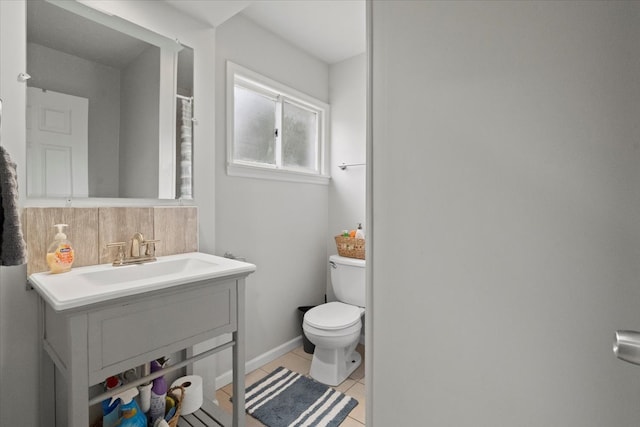 bathroom with tile patterned floors, vanity, toilet, and tasteful backsplash