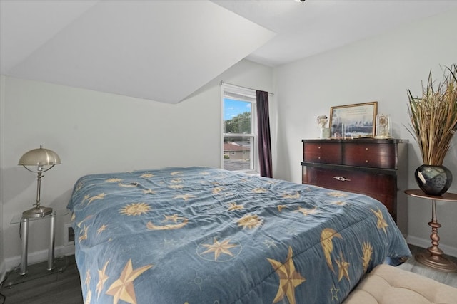 bedroom featuring vaulted ceiling and hardwood / wood-style flooring