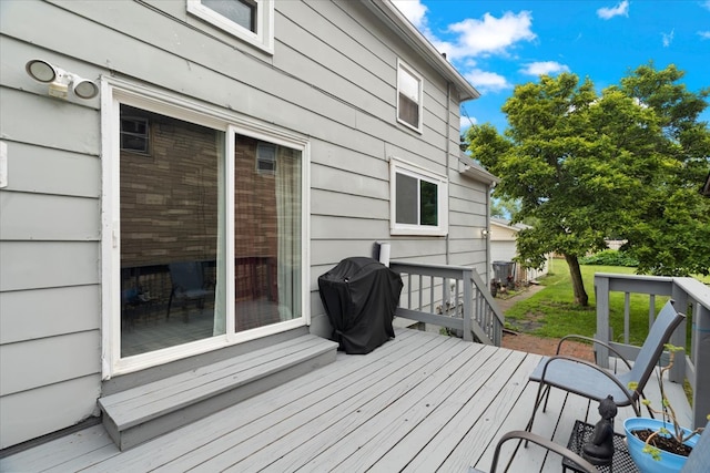 wooden terrace with a grill