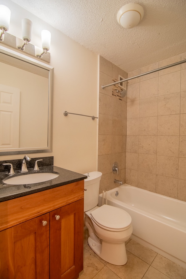 full bathroom featuring vanity, toilet, tile patterned flooring, and tiled shower / bath