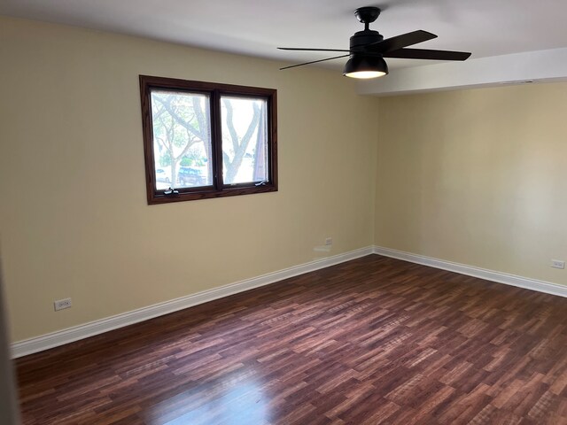 unfurnished room with ceiling fan and dark hardwood / wood-style floors