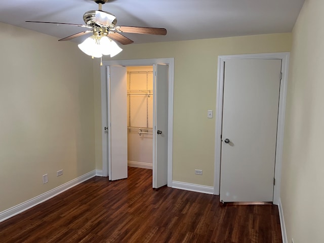 unfurnished bedroom with ceiling fan and dark hardwood / wood-style flooring