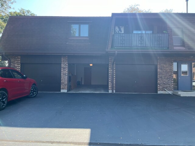 view of front facade with a garage and a balcony