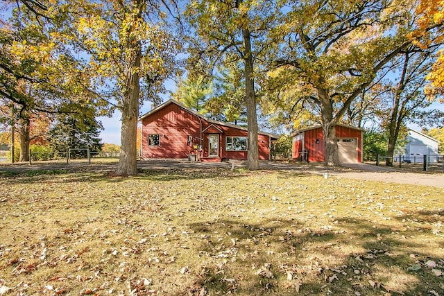 exterior space featuring a garage and an outbuilding