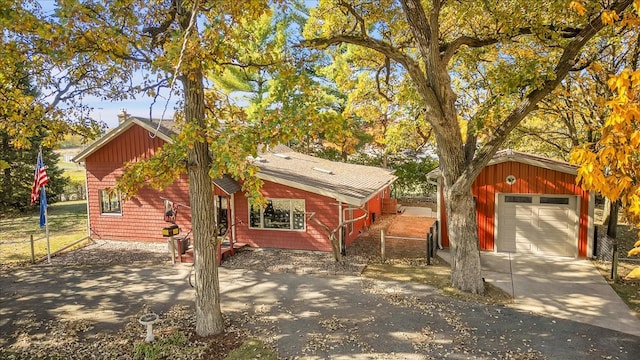 view of front facade featuring an outdoor structure and a garage