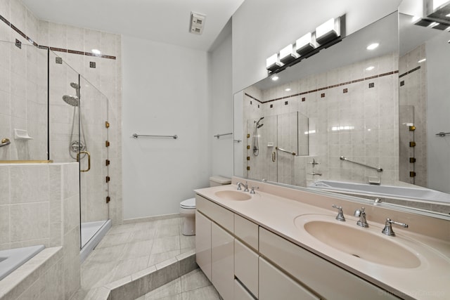 full bathroom featuring tile patterned flooring, plus walk in shower, vanity, and toilet