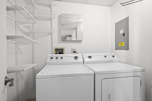 laundry area with electric panel and washer and dryer