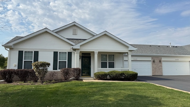 single story home featuring a front lawn and a garage