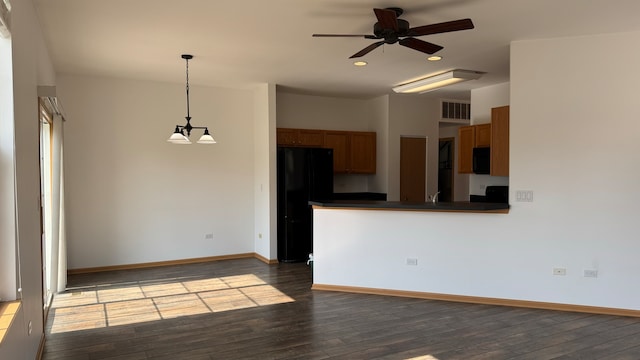 interior space with ceiling fan with notable chandelier and hardwood / wood-style floors