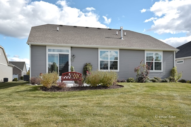 rear view of property with a yard