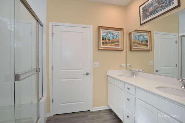 bathroom featuring vanity, a shower with shower door, and hardwood / wood-style flooring