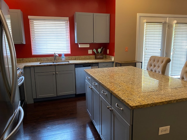 kitchen featuring gray cabinetry, sink, dark wood-type flooring, and appliances with stainless steel finishes