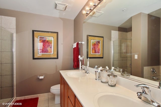 bathroom with walk in shower, vanity, toilet, and tile patterned floors